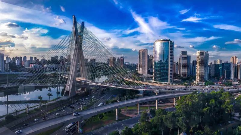Ponte estaiada sobre a Marginal Pinheiros, com pistas movimentadas e prédios comerciais ao fundo