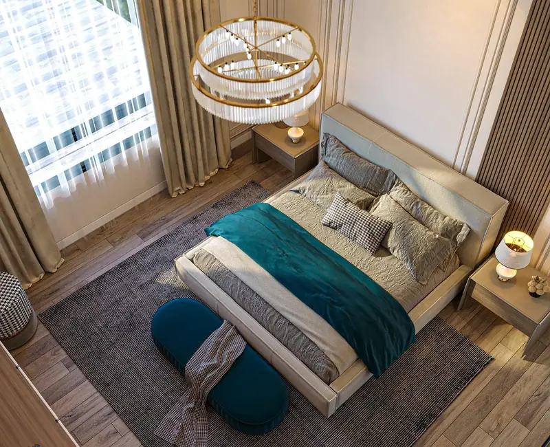 Quarto visto do alto, com cama de casal arrumada, manta verde, tapete e lustre de cristal