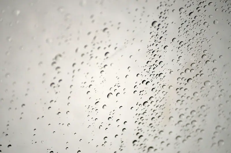 Vidro de box de banheiro coberto de gotas de vapor, visto de perto