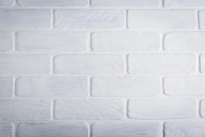 Parede de tijolos pintados de branco vista de perto