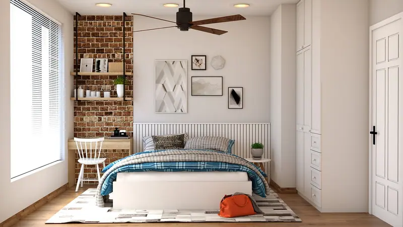 Quarto claro com cama de casal arrumada, parede de tijolinhos, escrivaninha e janela com persiana